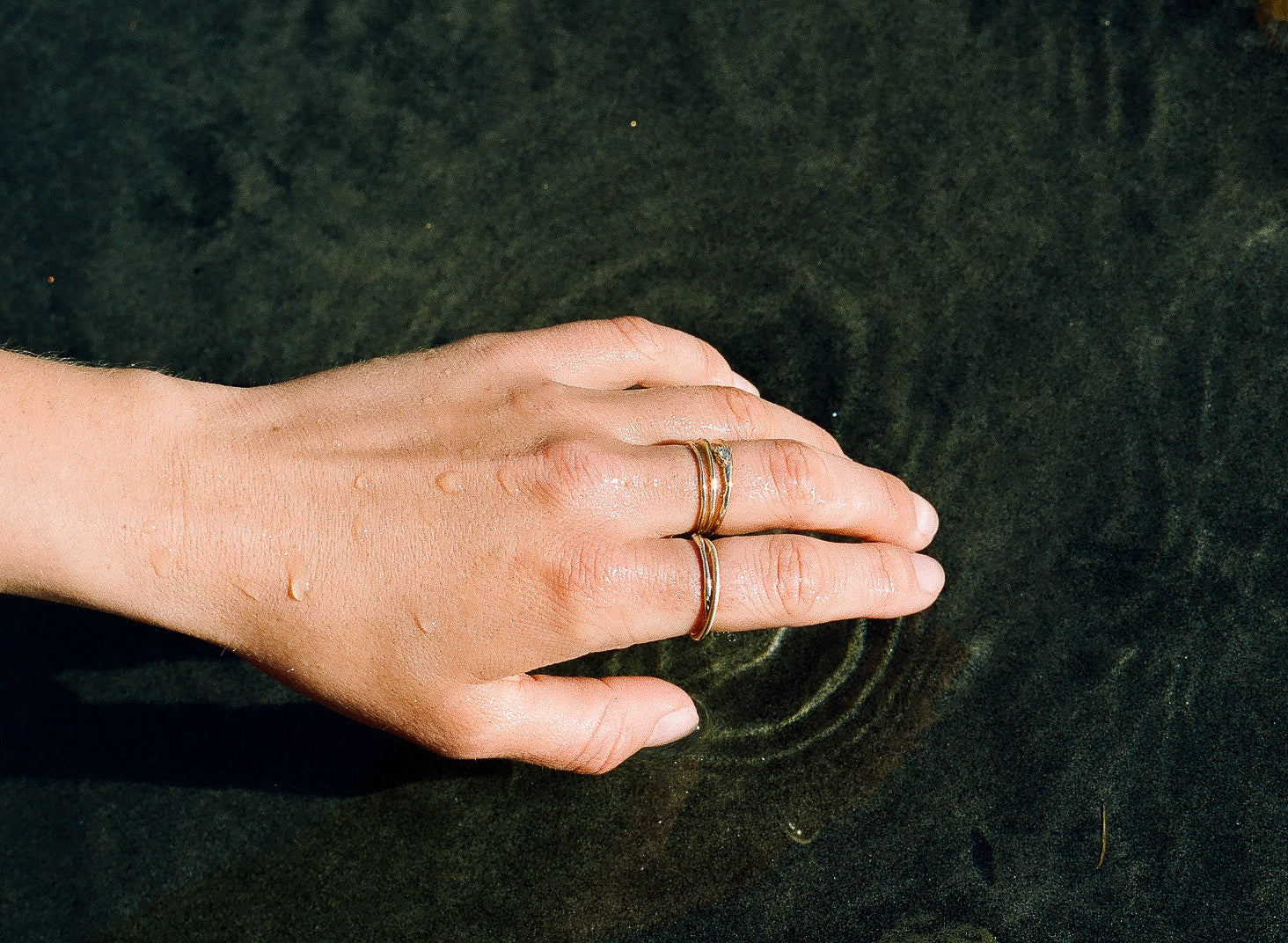 stacking rings on hand in water