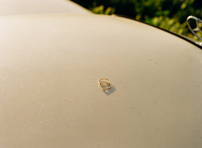 interlocking rings on hood of yellow 80s mercedes